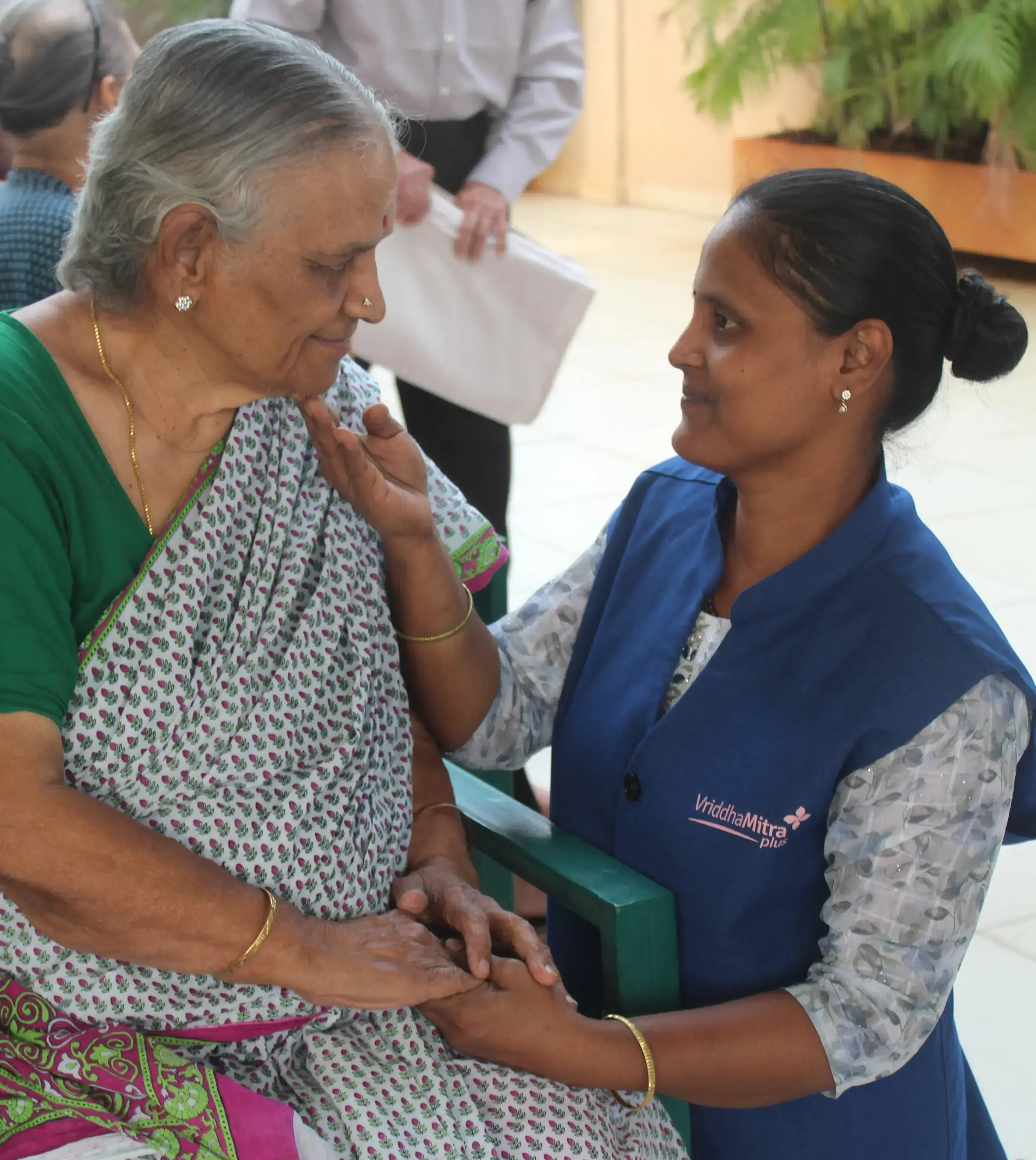 Caregiver and elder sharing a warm moment